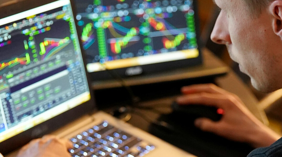 man analyzing charts on screen