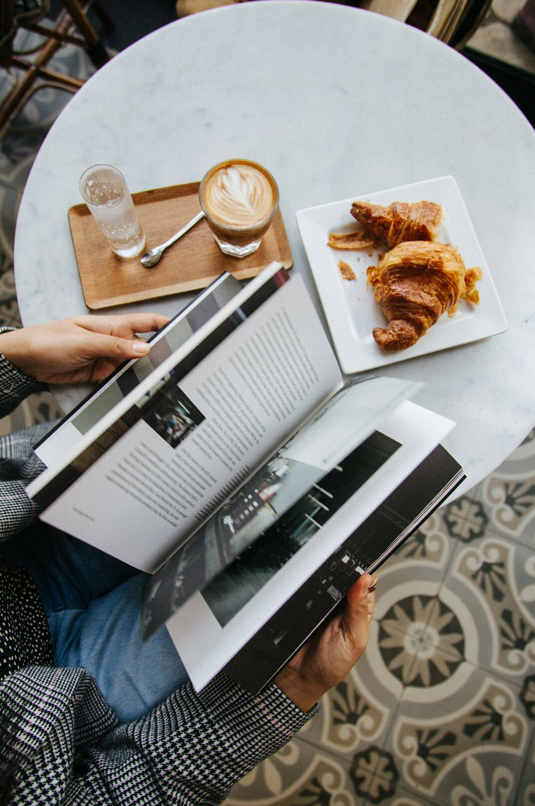 woman reading book at cafe