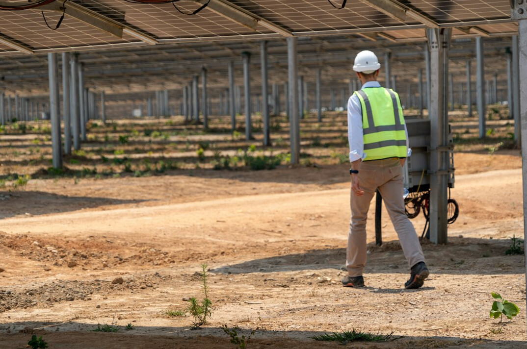 engineer inspecting solar panels